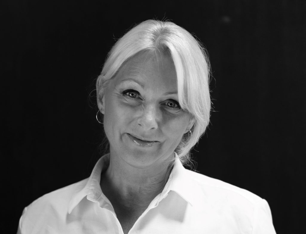 Portrettbilde av Siri Nodland, generalsekretær i Fundraising Norge. Hun har på seg hvit skjort og står mot sort bakgrunn. 